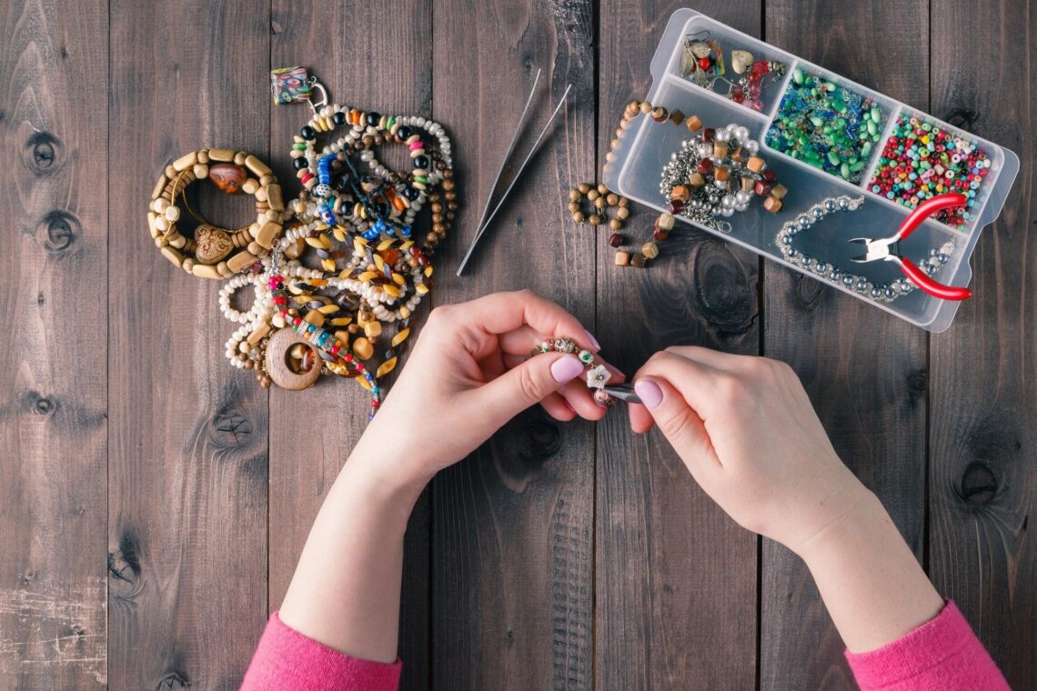 photo of woman making handmade jewelry